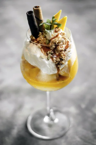 Mango and passion fruit tropical ice cream sundae in glass — Stock Photo, Image