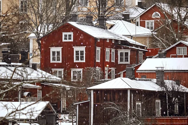 Old historic Porvoo, Finland with Traditional Scandinavian rural red wooden houses under white snow. Snowing — Zdjęcie stockowe