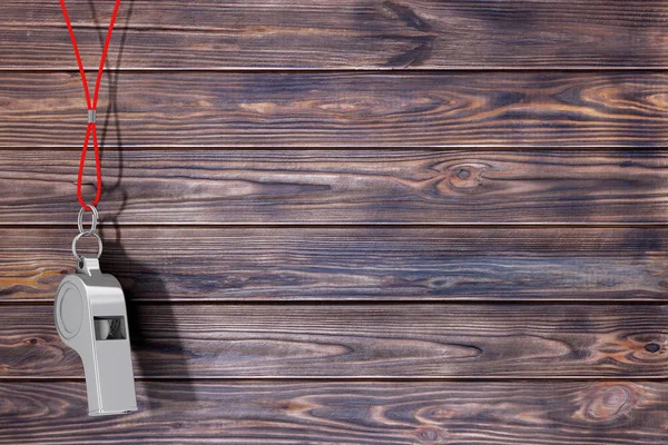 Classic Metal Coaches Whistle Hanging on Red Rope on a wooden planks background. 3d Rendering