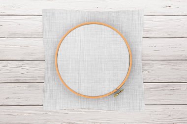 Çapraz dikiş ahşap Hoop için. Nakış ve tuval için bir tambur çerçeve ahşap bir masa üzerinde Your tasarımı için boş alan ile. 3D render 