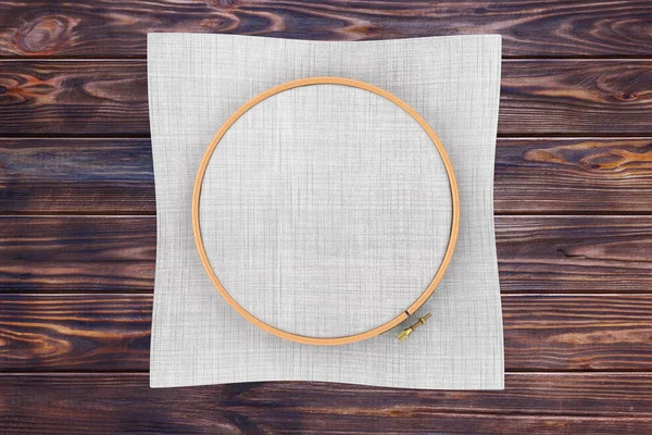 Wooden Hoop for cross stitch. A Tambour Frame for embroidery and Canvas with Free Space for Your Design on a wooden table. 3d Rendering