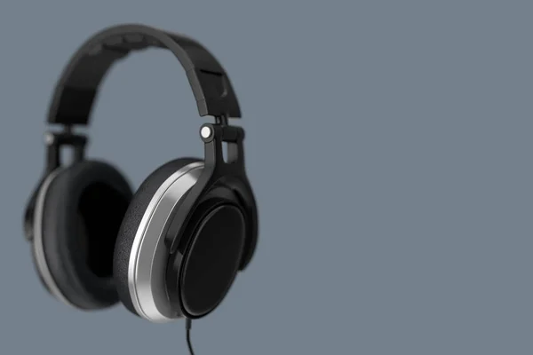 灰色背景上的黑色耳机 — 图库照片