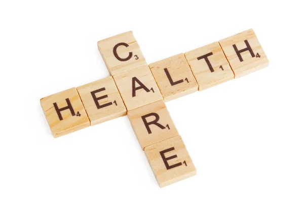 Health Care concept. Zorg teken als Kruiswoord houten blokken — Stockfoto
