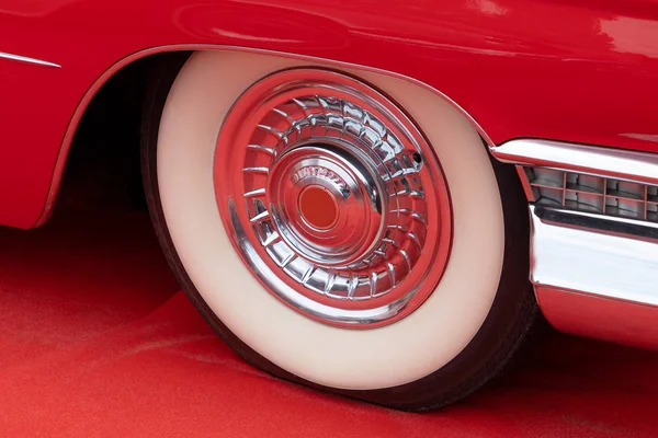 Red Retro Car Wheel on a Red Carpet Stock Photo