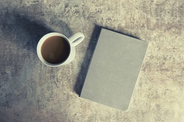 concrete background with coffee and book