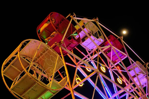 Ferris wheel turn around in carnival at fullmoon night