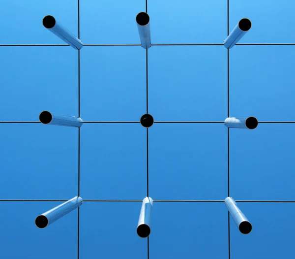 Metal rods (planks) against blue sky seen from below