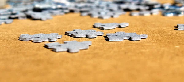Puzzle pieces on a table seen in perspective