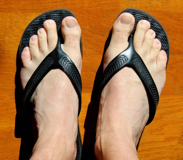 White man feet and flip flops thongs sandals