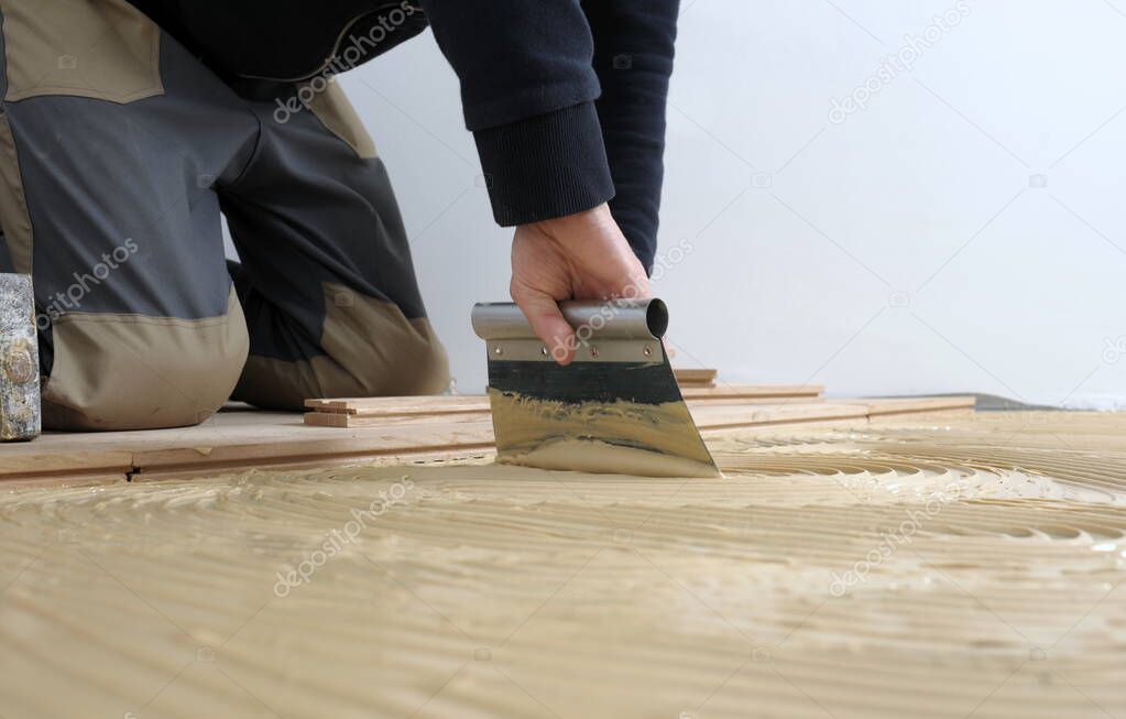 Worker applied adhesive for parquet