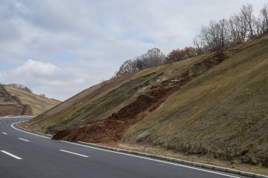 Danger landslide on the highway. Landslide on the access road clipart