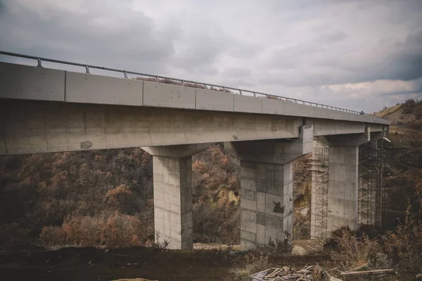 Bottom view on the bridge. Big concrete overpass. Building of the bridge. Bridge under construction