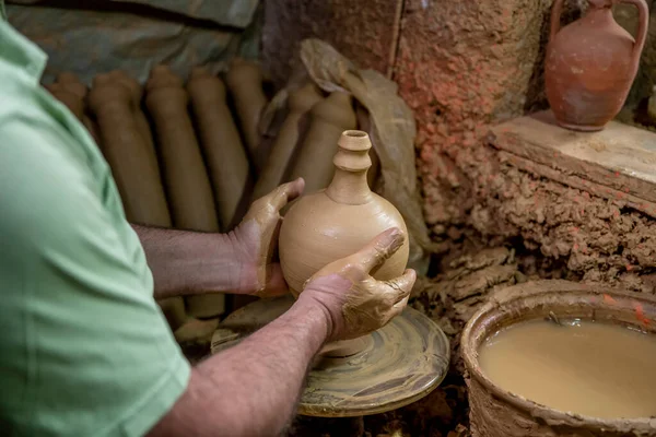 男性の陶芸家は陶器の車輪に鍋を作ります 回転ホイール上のテラコッタ陶器の男 土地の中心を持つ陶器のアイデアを作る男性 — ストック写真