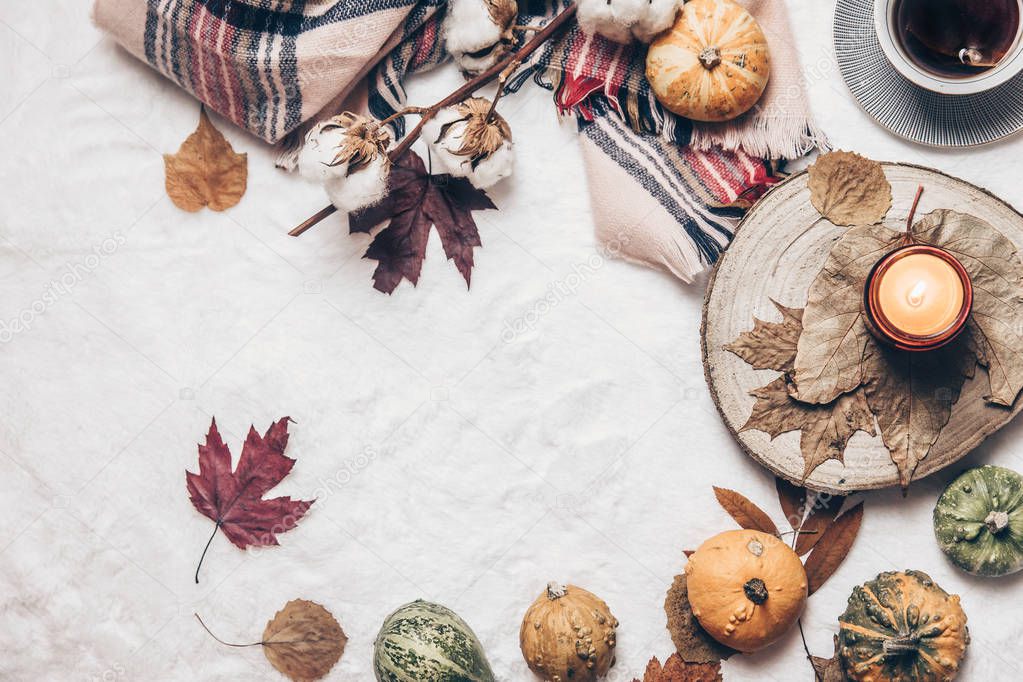 Autumn composition. Hot tea, autumn leaves, on cozy background. Flat lay, top view, copy space.