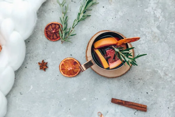 Mulled wine in mugs with spices and citrus fruit. Flat lay, top view