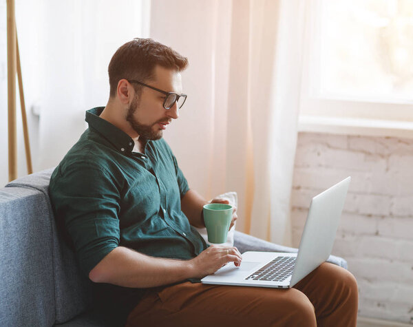 Happy man businessman, freelancer, student working at computer at home and offic