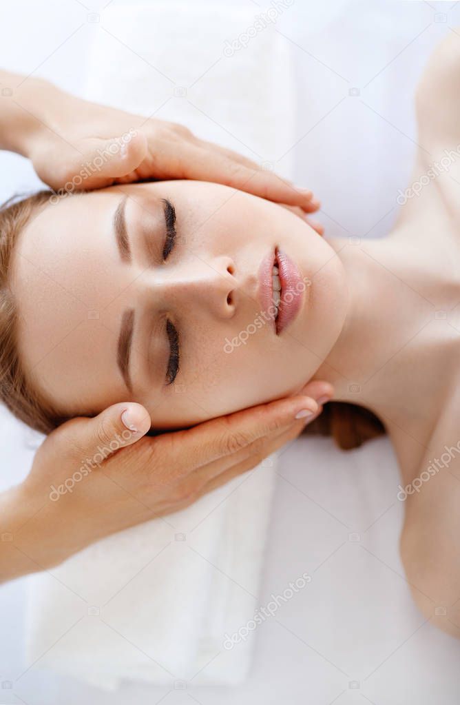 a beautiful girl enjoys massage and spa treatment