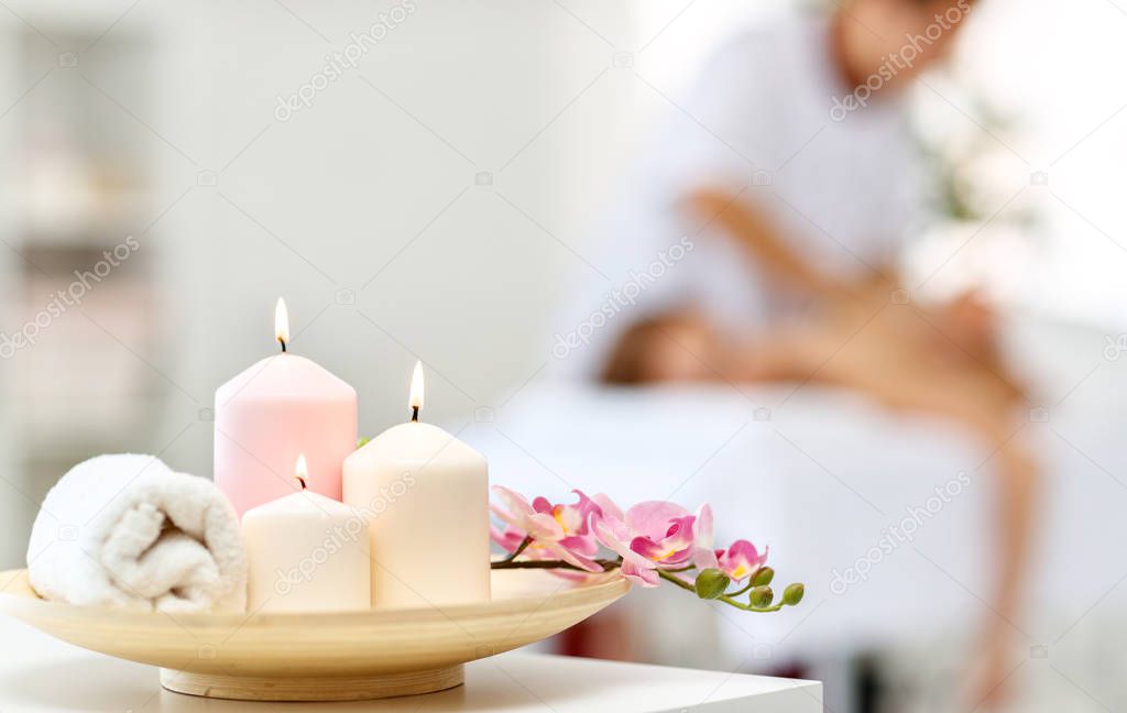 composition of spa candles and white towel