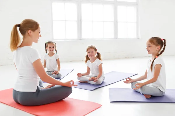 儿童练习是从事体操和瑜伽与教 — 图库照片