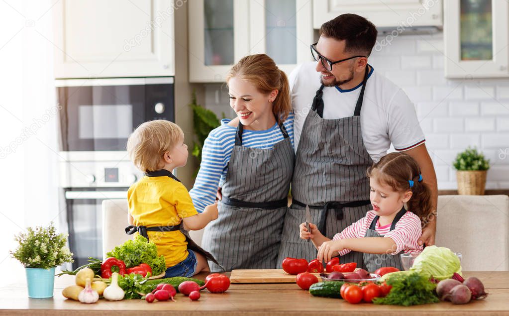 happy family with child  preparing vegetable salad at hom