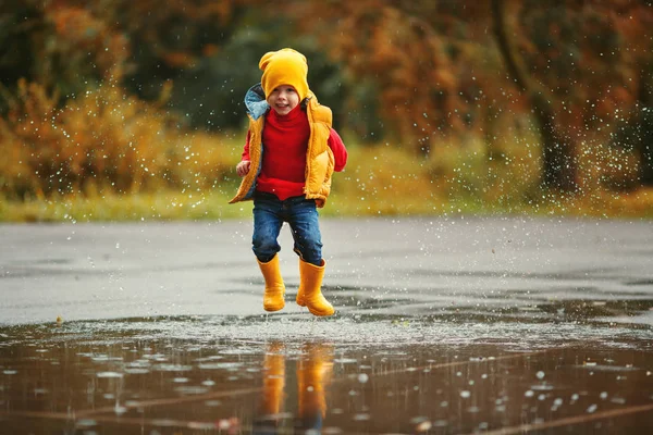 Happy Child Boy Rubber Boots Jump Puddle Autumn Wal — стоковое фото