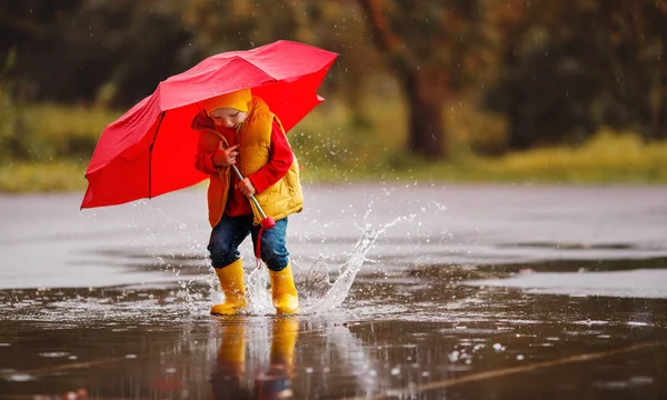 Happy Child Boy Rubber Boots Umbrella Jump Puddle Autumn Wal — стоковое фото