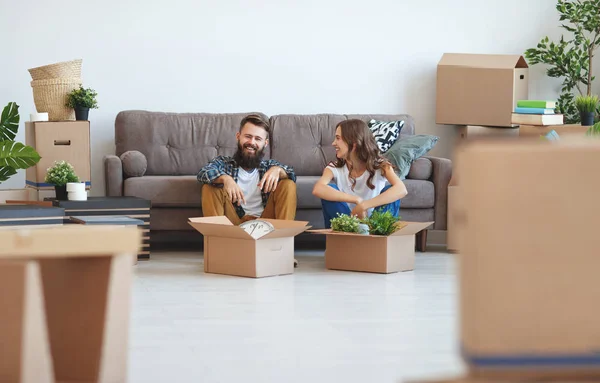 a happy young married couple moves to new apartmen