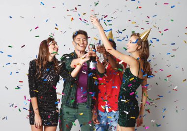 corporate party happy friends dancing with confetti and champagn clipart