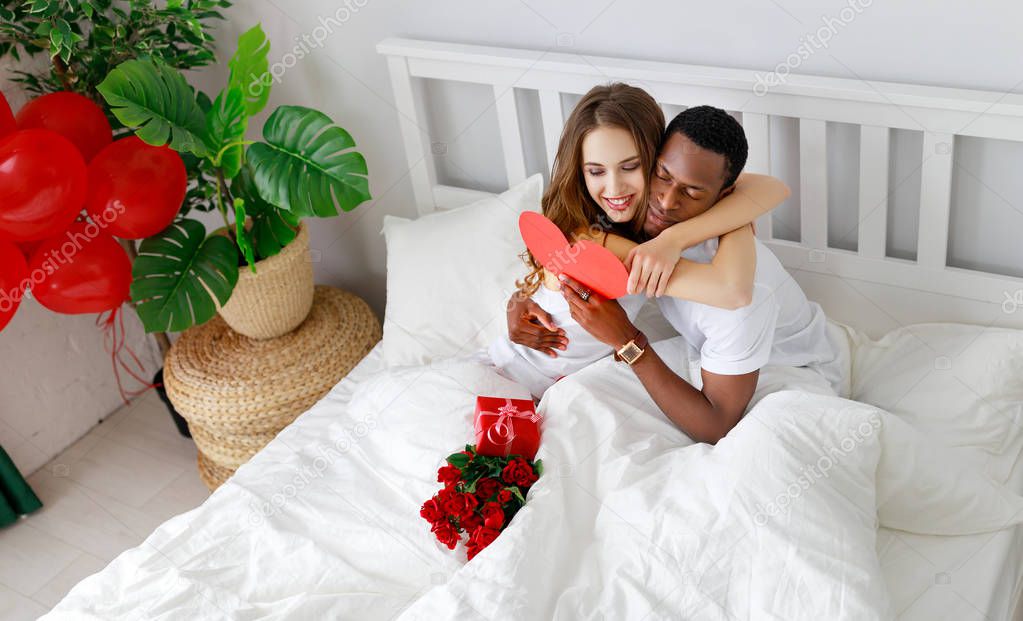 Valentine's Day. happy couple in love with red hert and flowers in be