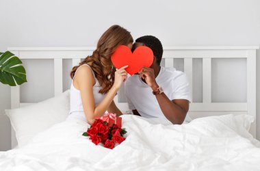 Valentine's Day. happy couple in love with red hert and flowers in be