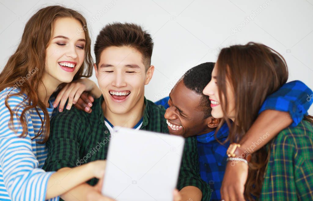 group of happy students people friends with phones tablets gadgets laugh
