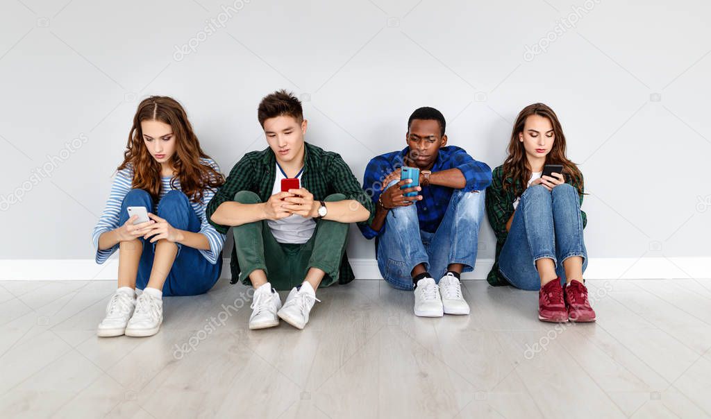 group of happy students people friends with phones tablets gadgets laug