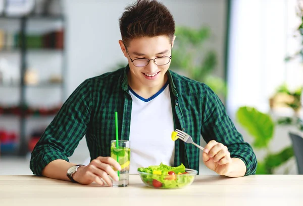 健康饮食 快乐的年轻人吃沙拉在早晨的厨房 — 图库照片