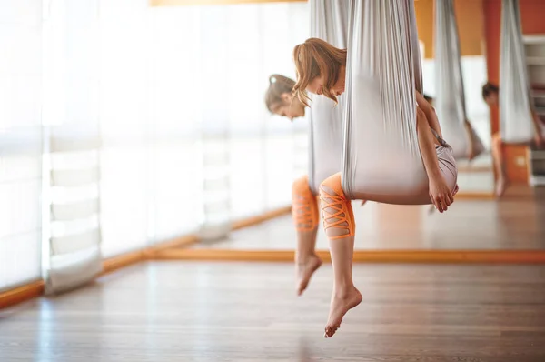 Group of people engaged in a class of yoga Aero in hammocks anti — Stock Photo, Image