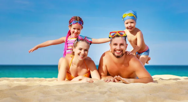 Happy family father, mother and children on  beach at sea — Stock Photo, Image