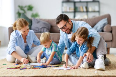 mutlu aile anne baba ve çocukların birlikte evde çizmek  