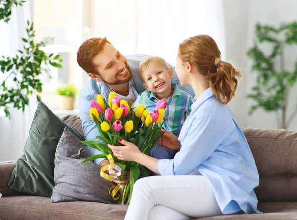 happy mother\'s day! father and child congratulate mother on holi