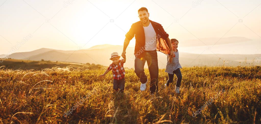 happy family father and children in nature at sunse