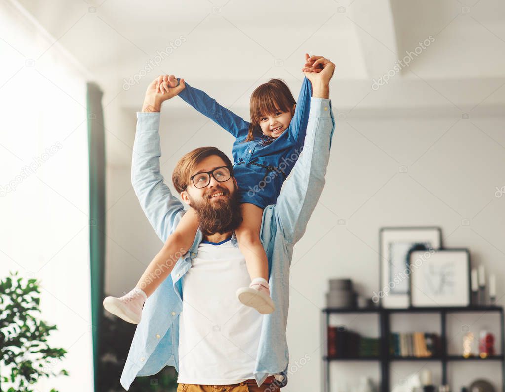 Father's day. Happy family daughter hugs his dad 