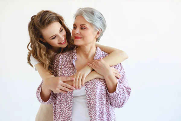 Family two generations old mother and adult daughter on whit — Stock Photo, Image