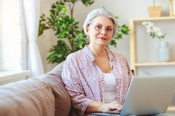 Gelukkige oude vrouw Senior werken bij computer laptop op hom — Stockfoto