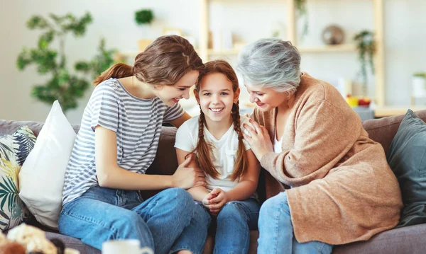 Family three generations  grandmother, mother and child play and — Stock Photo, Image