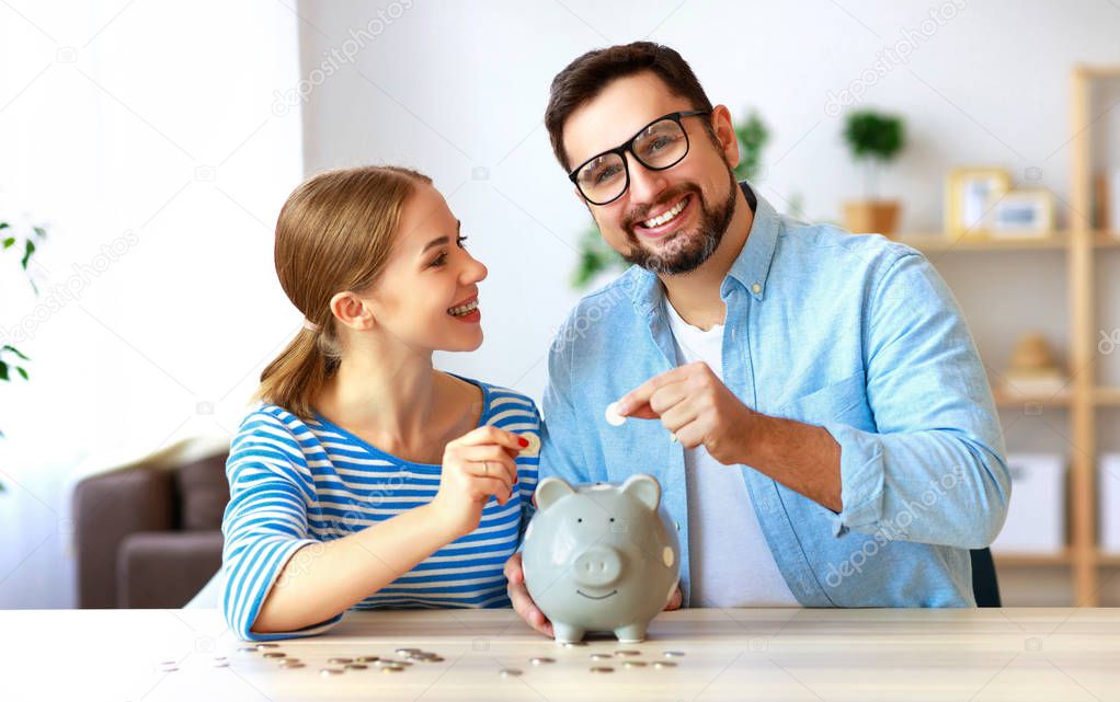 financial planning happy family couple with piggy Bank at home