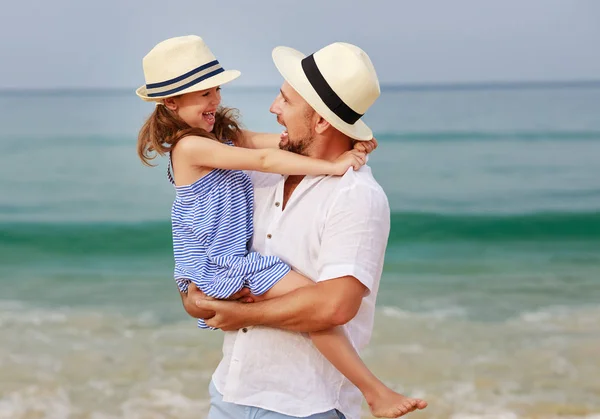 Familia feliz en la playa. padre e hija abrazo en el mar —  Fotos de Stock