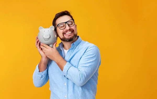 Concept of Finance and business.  man with  piggy Bank on  yello — Stock Photo, Image