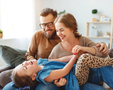 mutlu aile anne baba ve çocuk kız evde gülüyor