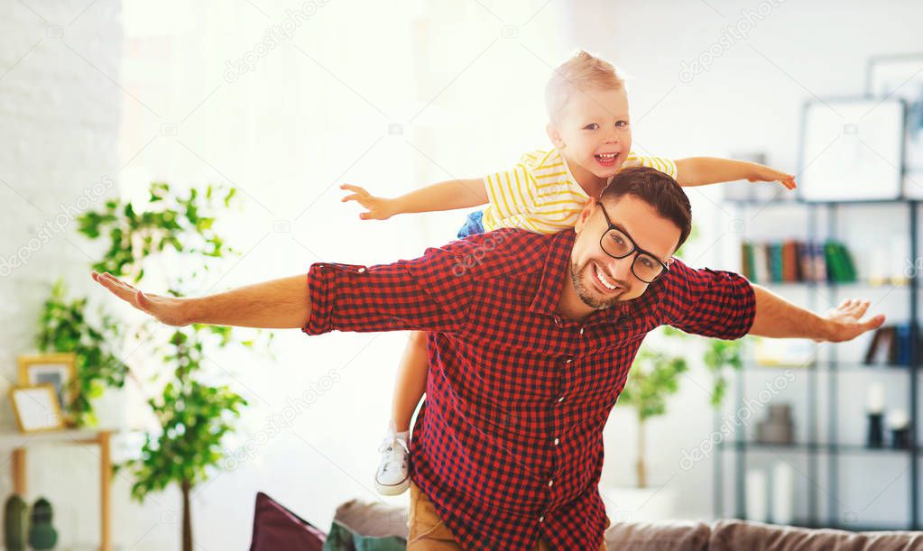 Father's day. Happy family son hugs his dad 