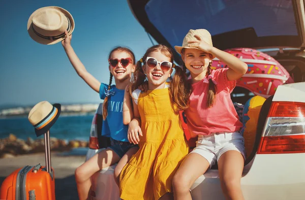 Happy children girls friends sisters on the car ride to summer t — Stock Photo, Image