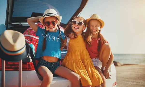 Happy children girls friends sisters on the car ride to summer t — Stock Photo, Image