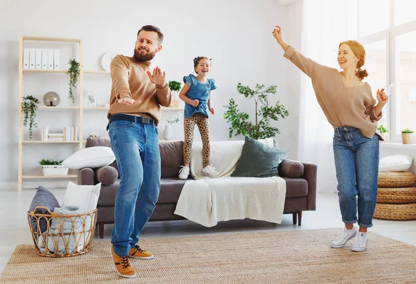 Happy family mother and child daughter dancing at home — стоковое фото